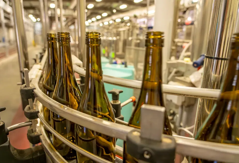 Production-line scene for bottle preparation & component feeding